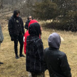 Photo of local high schoolers learning about water science with university faculty and students.