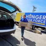 Photo of Rick Lewandowski, Milwaukee native and UW Oshkosh alum, who oversees 400 volunteers for the Hunger Task Force, delivering and distributing 10,000 boxes of healthy foods to low-income seniors free of charge.