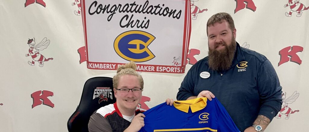 Photo of UW-Eau Claire esports gamer: First-year student Christopher Brockert, left, received a $2,000 esports scholarship for the 2024-25 academic year. Nate Garvey, right, advisor for the university’s Esports Club, was at Kimberly High School for Brockert’s signing day.