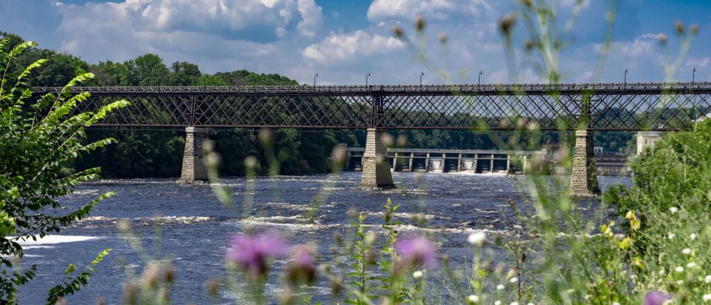 Photo of the 900-foot-long High Bridge that spans the Chippewa River just downriver from Dell’s Dam, which is officially named the Chicago, St. Paul, Minneapolis and Omaha Railway Bridge, but is referred to locally as the High Bridge because its deck is approximately 80 feet above the normal river level.