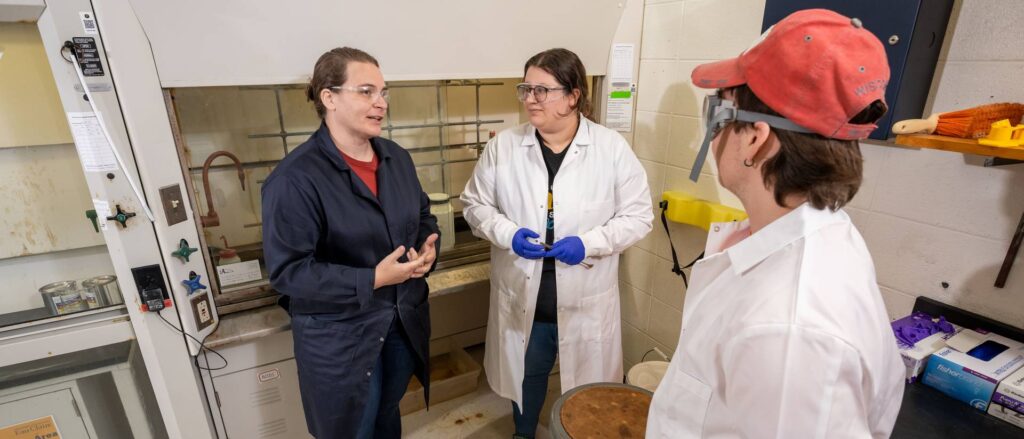 Photo of (from left) Dr. Deidra Gerlach, associate professor of chemistry and biochemistry, working with students Jackie Bradley and Connor Koepp.