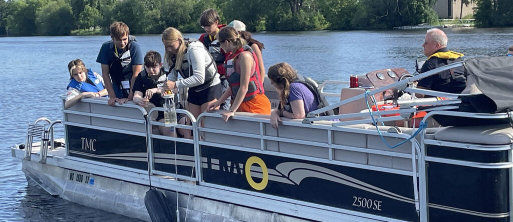 Photo of high school students from Wisconsin and Illinois taking freshwater samples. The UW Oshkosh Environmental Research and Innovation Center (ERIC) hosted 18 high school students from Wisconsin and Illinois for its inaugural residential “Freshwater High School Experience” on the UW Oshkosh campus. Opportunities such as these encourage high school students t pursue degrees and careers in water science. 