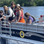 Photo of high school students from Wisconsin and Illinois taking freshwater samples.