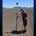 Photo of UW-Platteville researcher demonstrating precision agriculture. “Precision agriculture is all about software and mapping the field,” said Dr. Joseph Sanford, assistant professor of soil and crop science. “We aim to introduce common industry software to give our students familiarity with it, so they’re well-prepared when they start their new jobs.”