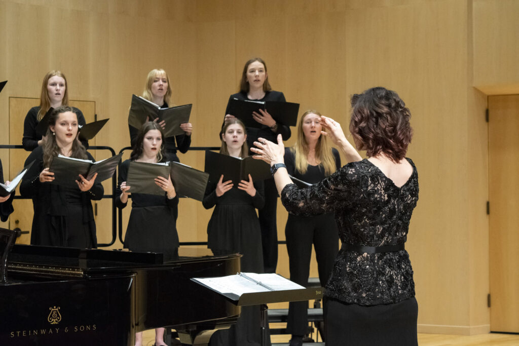 Photo of Kourtney Austin, a UW-La Crosse assistant professor of Music pictured here conducting. (Photo credit: Dakota Kallas)