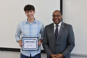 Photo of Suscha, pictured with Chancellor Tom Gibson, who earned first place at the UW-Stevens Point WiSys Quick Pitch competition.