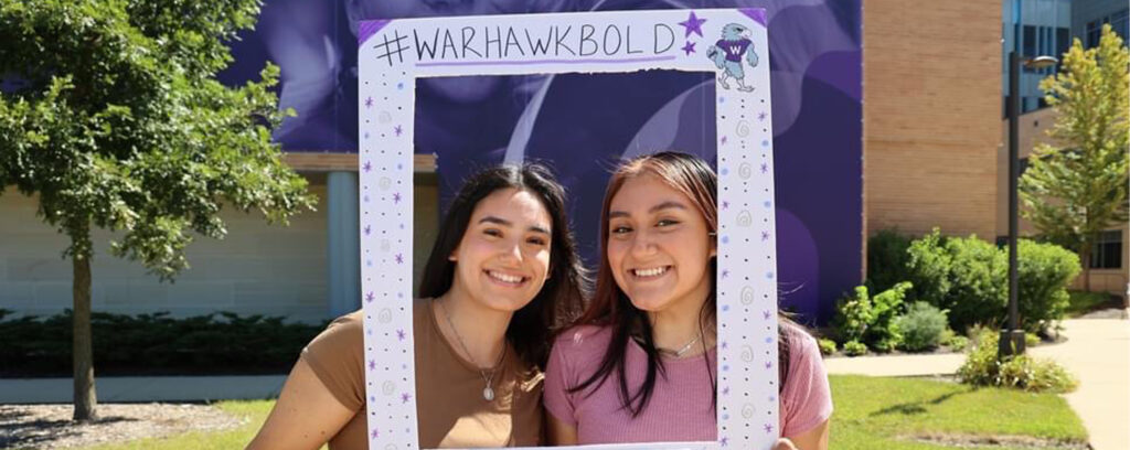 Photo of Maribel Rodriguez (left) and Alma Diaz-Cosme posing for a photo outside of Hyland Hall on the first day of classes for the fall semester on Sept. 3, 2024. (Photo courtesy of Diaz-Cosme and Rodriguez)