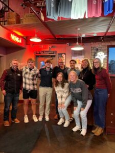 Photo of the Jungbluths, who recently met with a group of their scholarship recipients. Eric is pictured back row, center. Kristin is pictured back row, second from right.