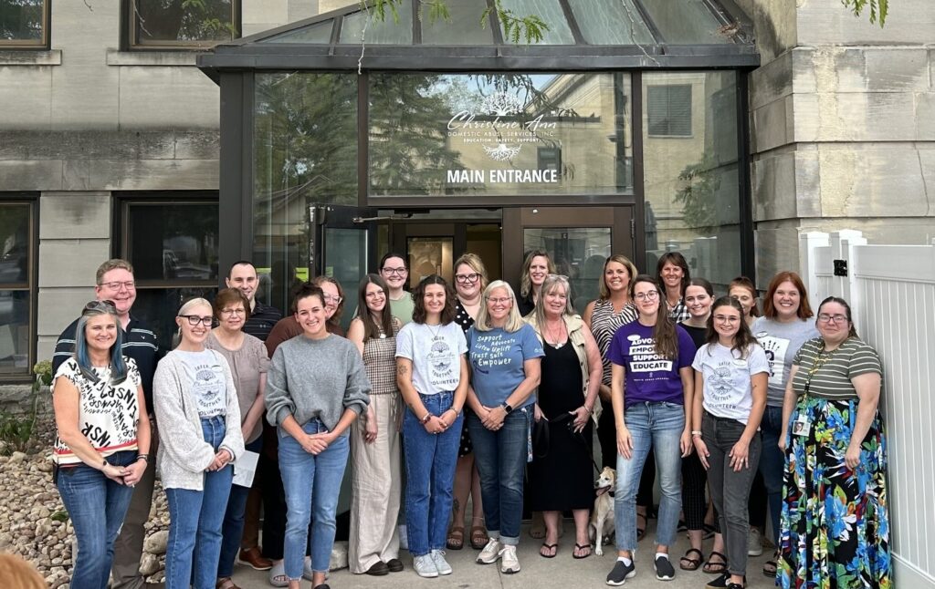 Photo of the 26-member team serving Christine Ann Domestic Abuse Services Inc.; the team now includes 17 UWO alumni. The organization transitioned the agency to a new shelter and agency headquarters (pictured here) on Algoma Boulevard in 2024. (Photo courtesy of Christine Ann Domestic Abuse Services Inc.)