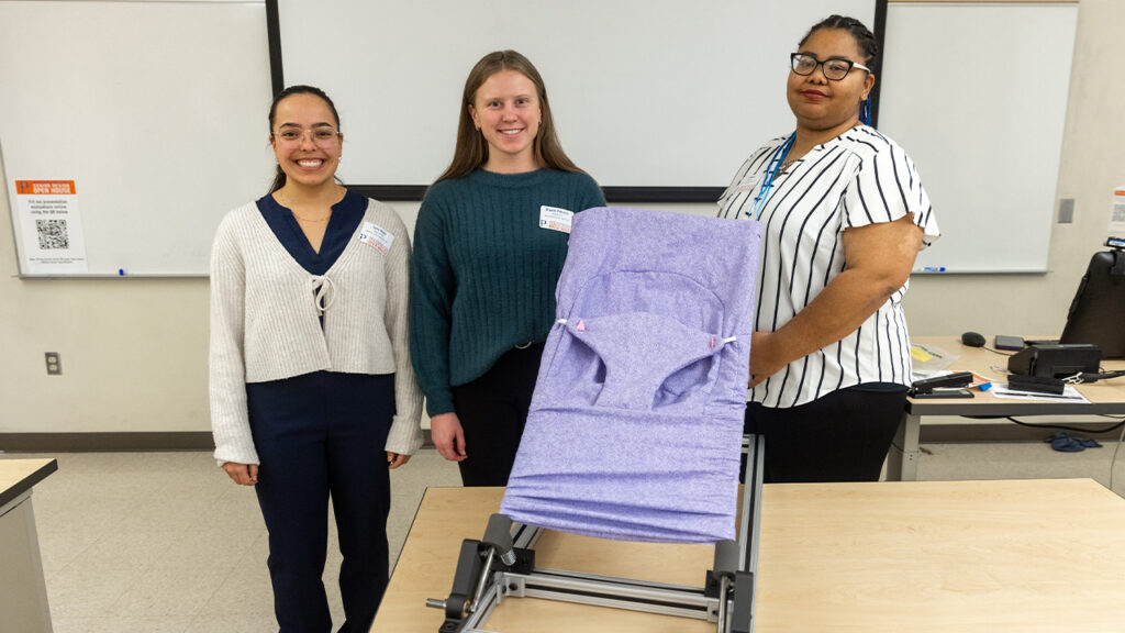 Photo of Taylor Nisius, Bryanne Pinkowski and JJ Hilliard pictured with their Gentle Jumps chair. (Photo credit: UW-Platteville)