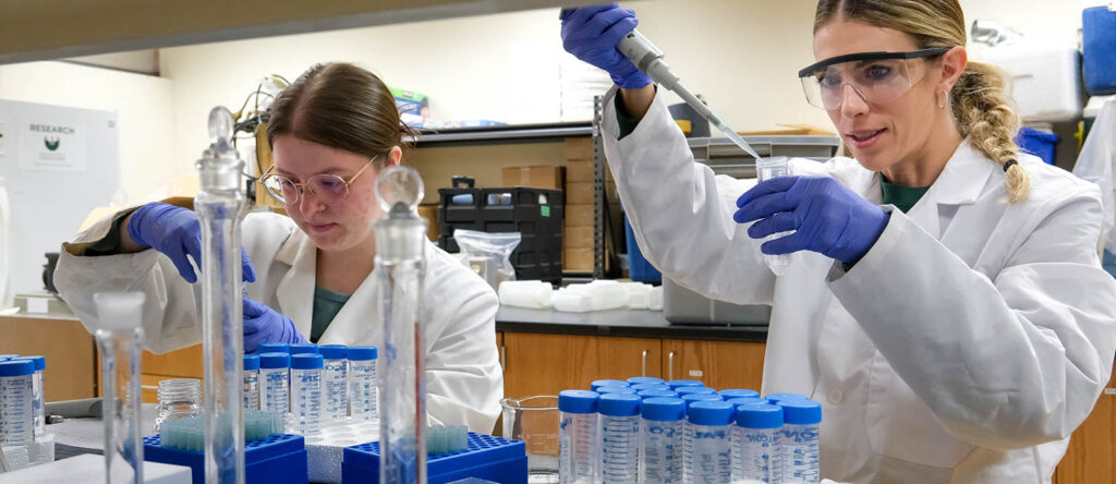 Photo of UW-Green Bay undergraduates Claire Igielski and Jessie Kreiling, who are studying phosphorous concentrations along the Wisconsin River. Photo courtesy UW-Green Bay, Sue Pischke University Photographer