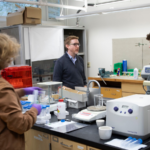 Photo of Steven Girard, an associate professor of chemistry at UW-Whitewater, in a university science lab.