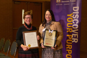 Photo of Chancellor Blank receiving her resolution of appreciation from Regent Vice President Walsh