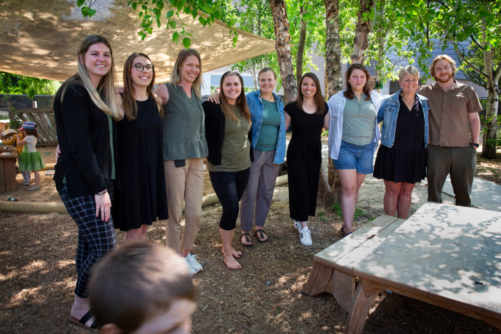 Photo of the staff of the UW-Whitewater Children’s Center outside their offices and classrooms on May 13, 2024. Children’s Center director and lead teacher Chelsea Newman is fourth from right. (UW-Whitewater/Craig Schreiner)