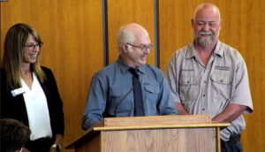 Photo of UW-Stout custodial leads (from left) Aimee Lipke, Bob Cook, and Brad Mengeling accepting the 2024 University Staff Excellence Award on behalf of the UW-Stout Custodial Program.