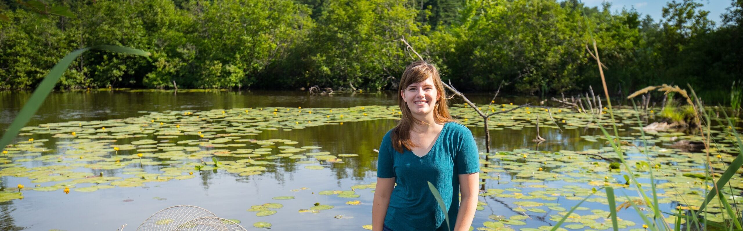 Student standing in a river